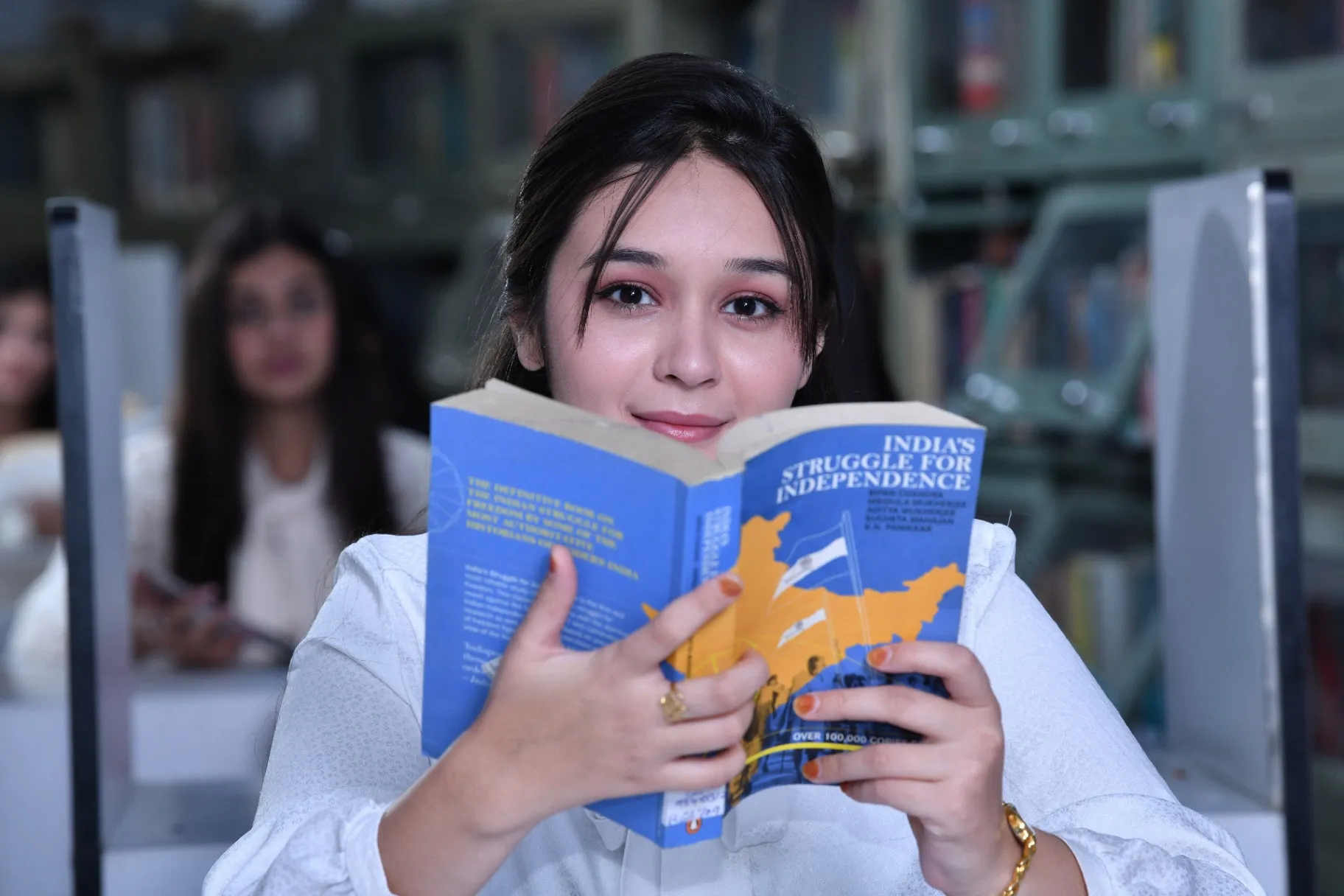 Student reading book in IIS University library Jaipur for girls higher education